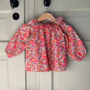 PDF sewing pattern downloadable for baby blouse with raglan sleeves and ruffled collar